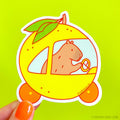 Capybara Driving a Yuzu Car Vinyl Sticker